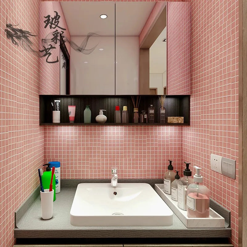 Ceramic mosaic bathroom wall tiles in light pink square grid pattern.