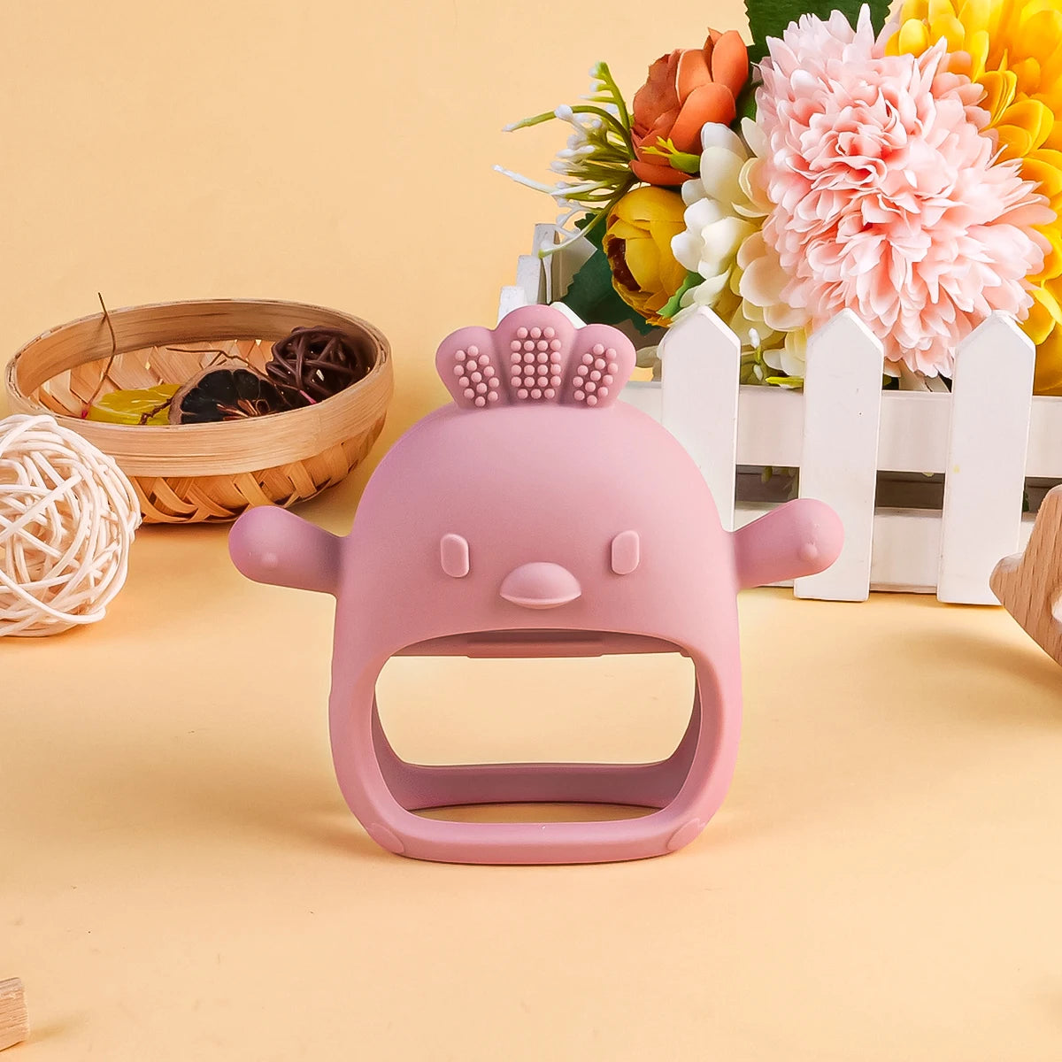 Pink silicone baby teething toy shaped like a chicken for soothing sore gums.