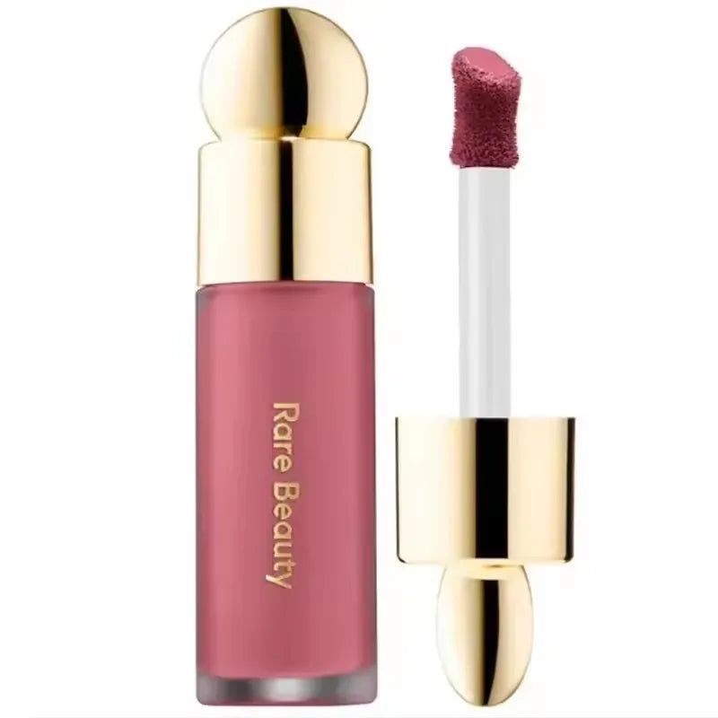 Rare Beauty matte lipstick in rich pink with gold cap, showing smooth texture applicator and luxury packaging.
