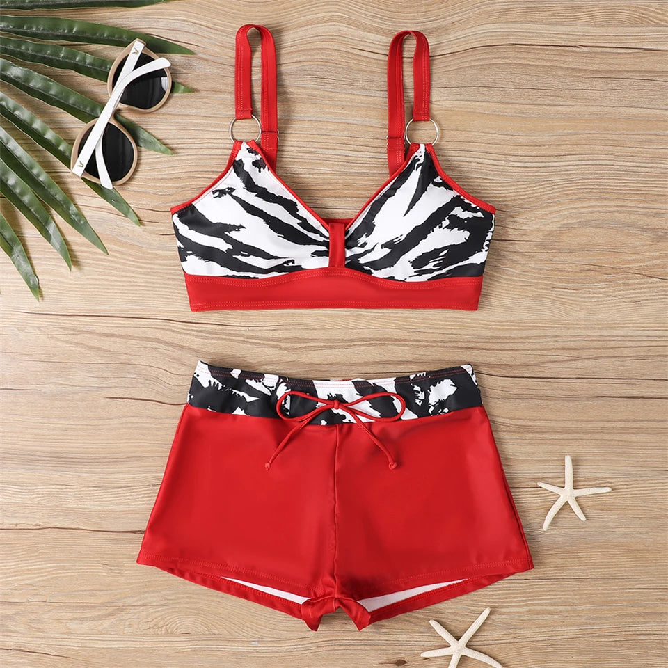 Tidesmit red and black zebra print high-waisted bikini set featuring a ring-detail sports bra top and tie-waist shorts.
