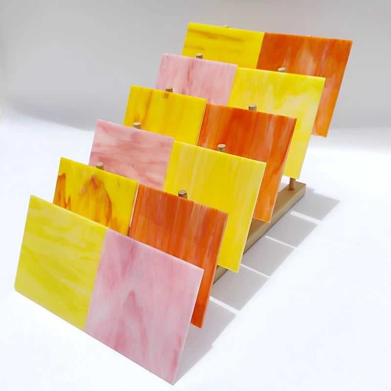 Assorted textured translucent stained glass square tiles, yellow, orange, pink, red, light colors