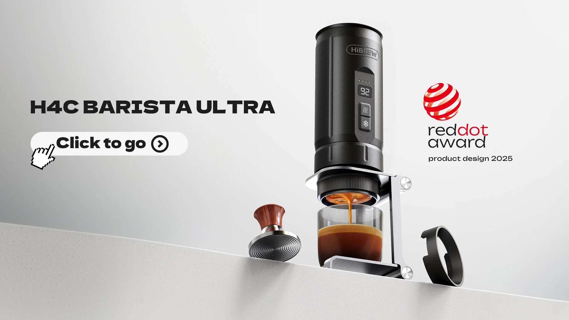 HiBREW H4C Barista Ultra portable espresso maker in black, dispensing coffee into a glass with a wood handle tamper.