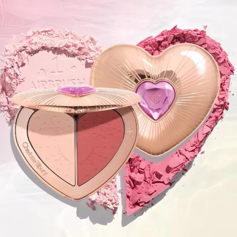 Charlotte Tilbury heart-shaped blush compact with rose gold case and pink powder blush, set against pink powder heart.