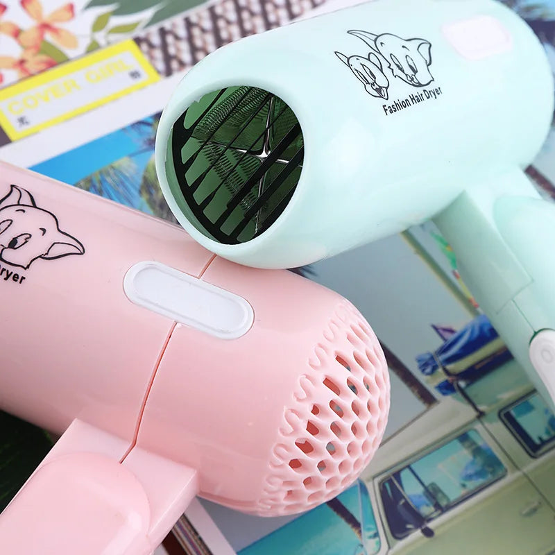 Cute pastel pink and mint green mini folding hair dryers, 400W low power travel tool with cartoon animal print.