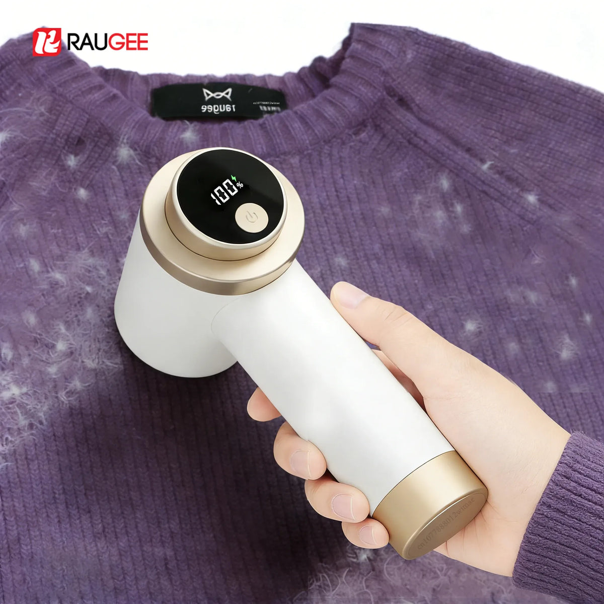 Fabric shaver lint remover with digital battery display removing fuzz from a purple wool sweater.