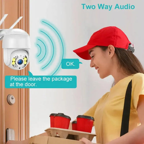 White wireless PTZ dome security camera mounted beside a doorway, with speaker mic vents.