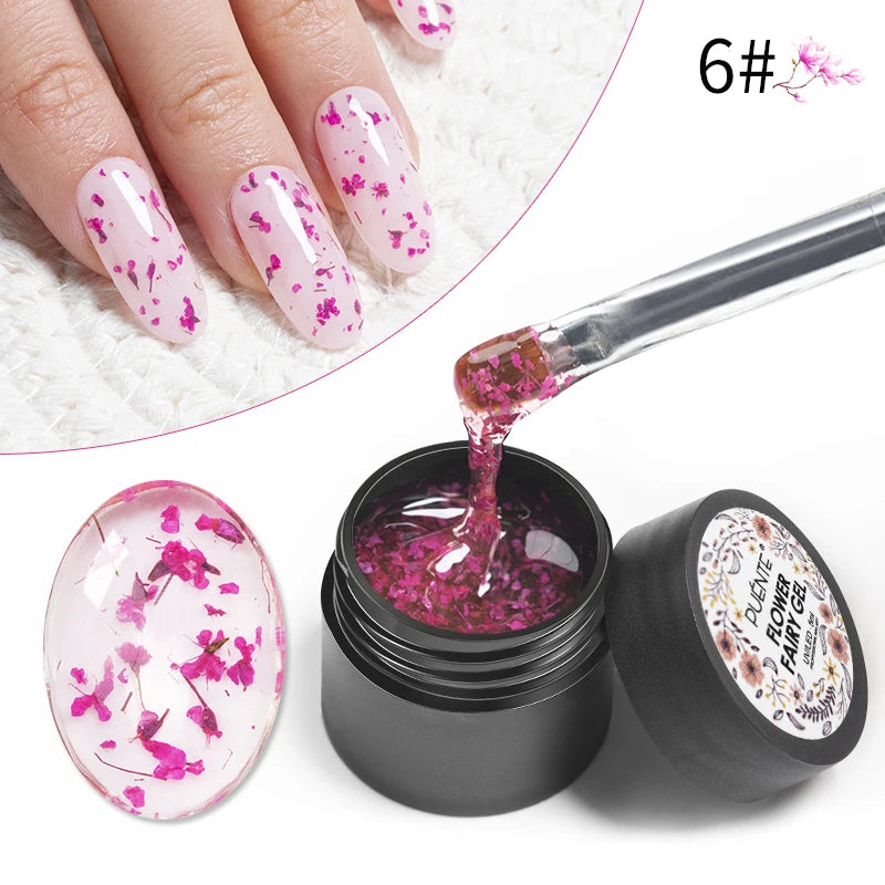 Clear nail gel with small pink dried flowers in a black jar, shown applied to fingernails with a brush.