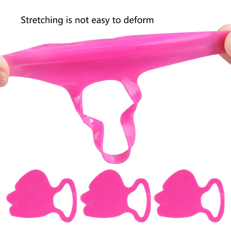 Bright pink, flexible silicone anti-wrinkle face patches, being stretched by fingers, showing durable material.