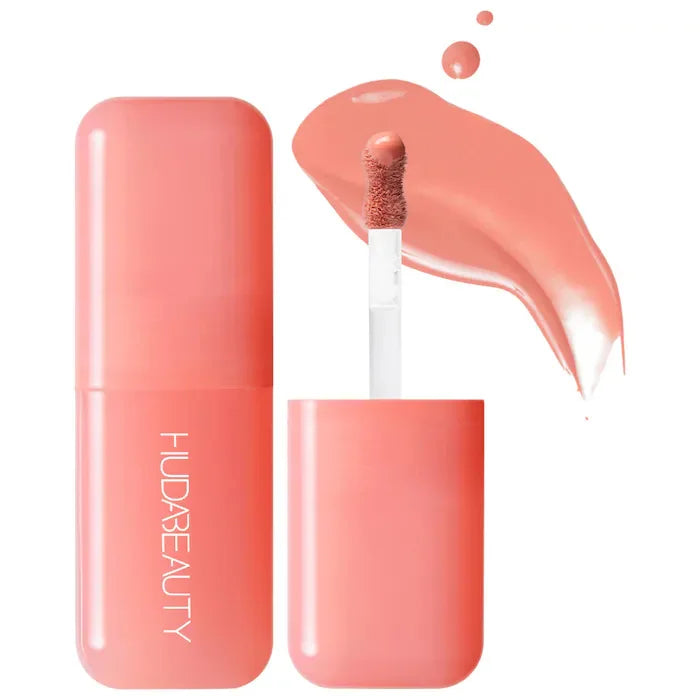 Peach-toned hydrating lip and cheek tint stick with creamy texture and applicator swatch on white background.