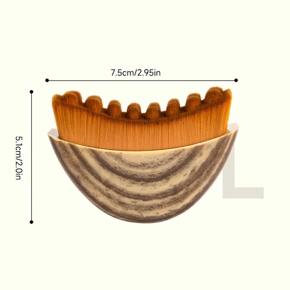 Curved facial massage brush with brown bristles and a marbled, semi-circular handle with dimension labels.