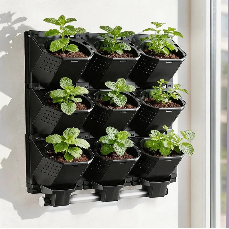 Black modular vertical garden planter with multiple cups holding small leafy plants