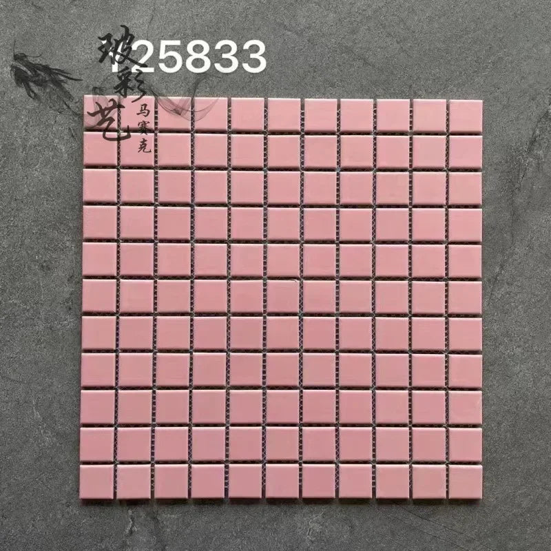 Ceramic mosaic tile sheet with small square pink tiles on grid backing