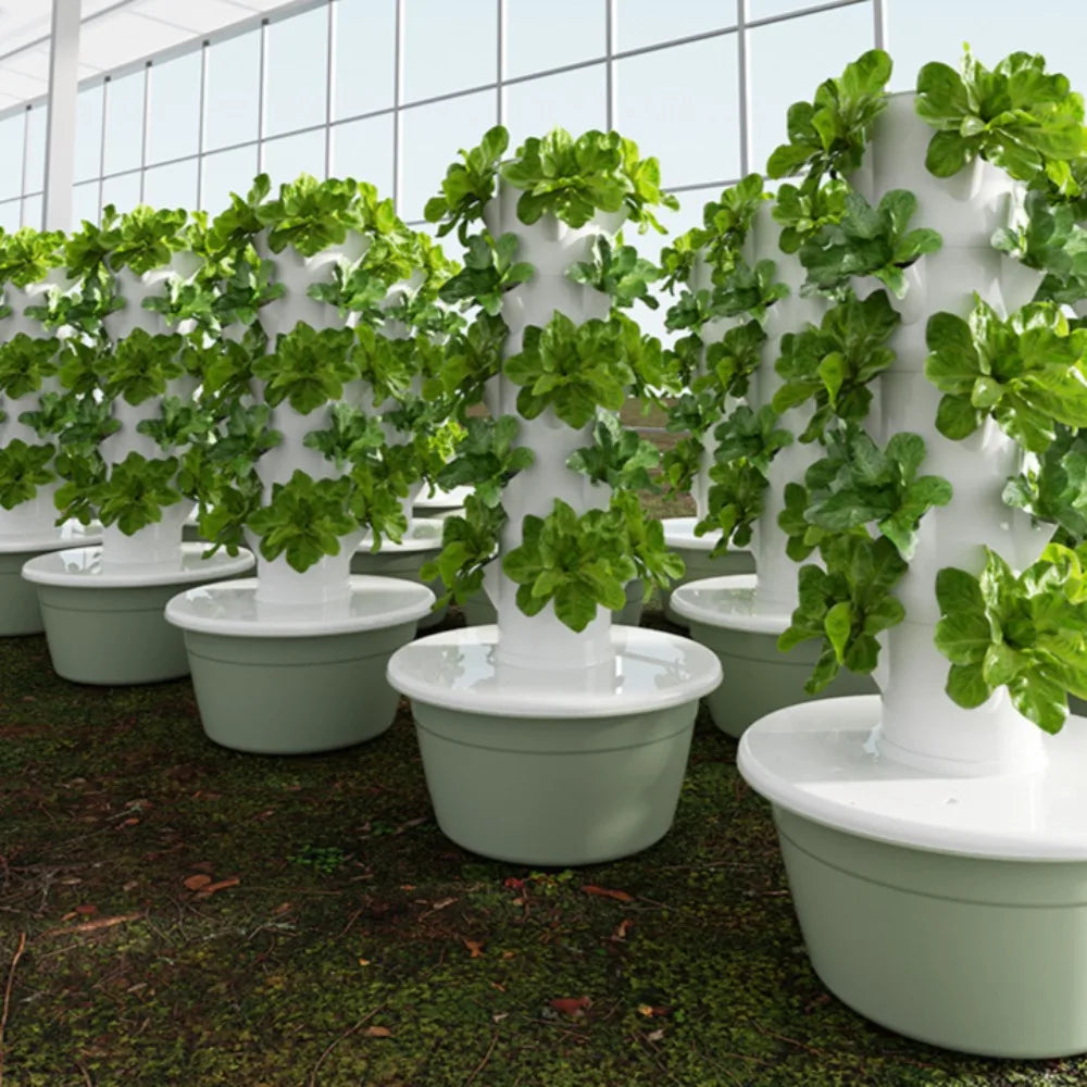 Vertical aeroponic tower garden with leafy green herbs in white net pots