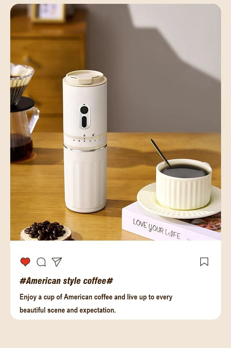 Portable white electric coffee maker on a wooden table with a matching cup of American coffee and coffee beans.