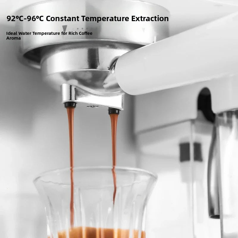 White espresso machine with stainless steel portafilter pouring fresh coffee into a clear glass.