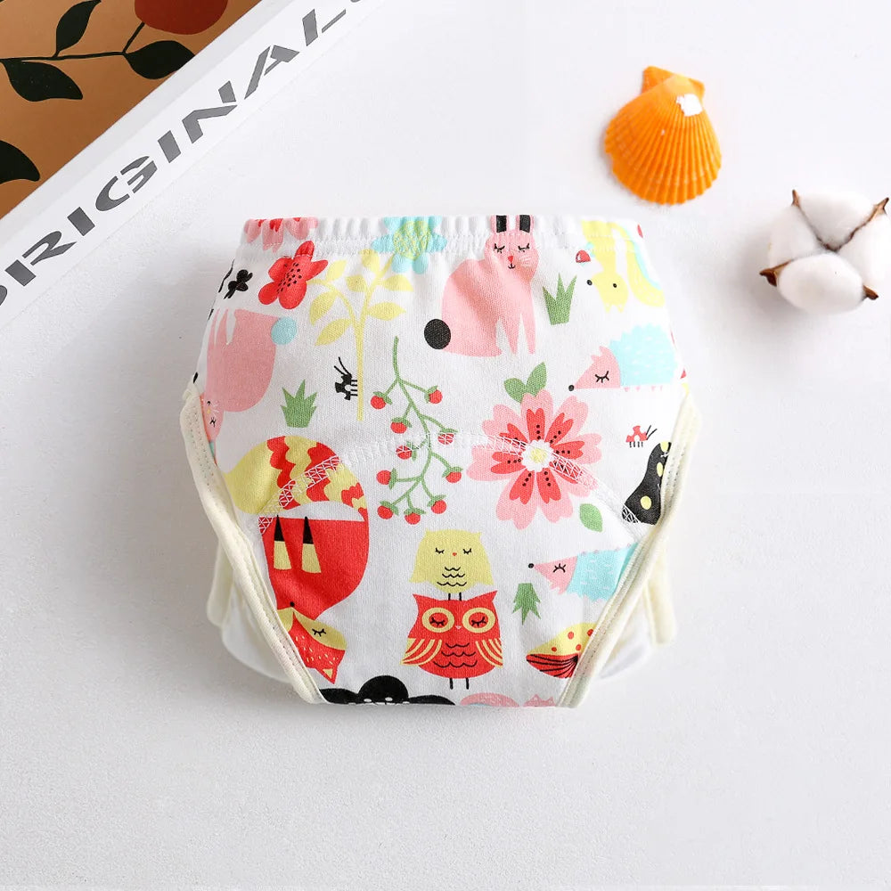Reusable baby cloth diaper with colorful woodland animal and floral print.