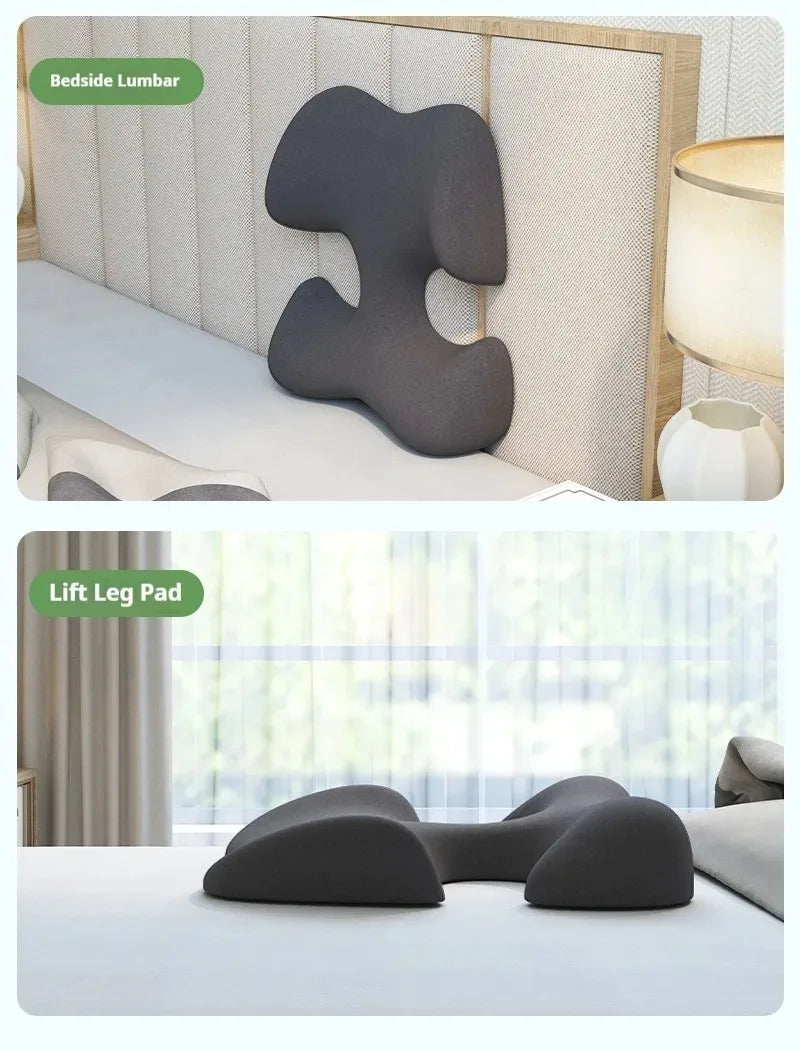 A dark grey, uniquely shaped foam pillow shown as both a bedside lumbar support and a leg elevation cushion.