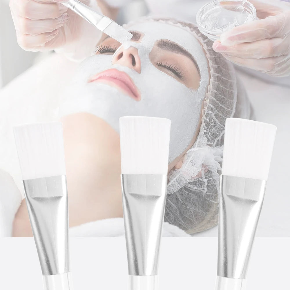 Three cosmetic facial mask brushes with white synthetic bristles and silver metal ferrules for applying skin treatments.