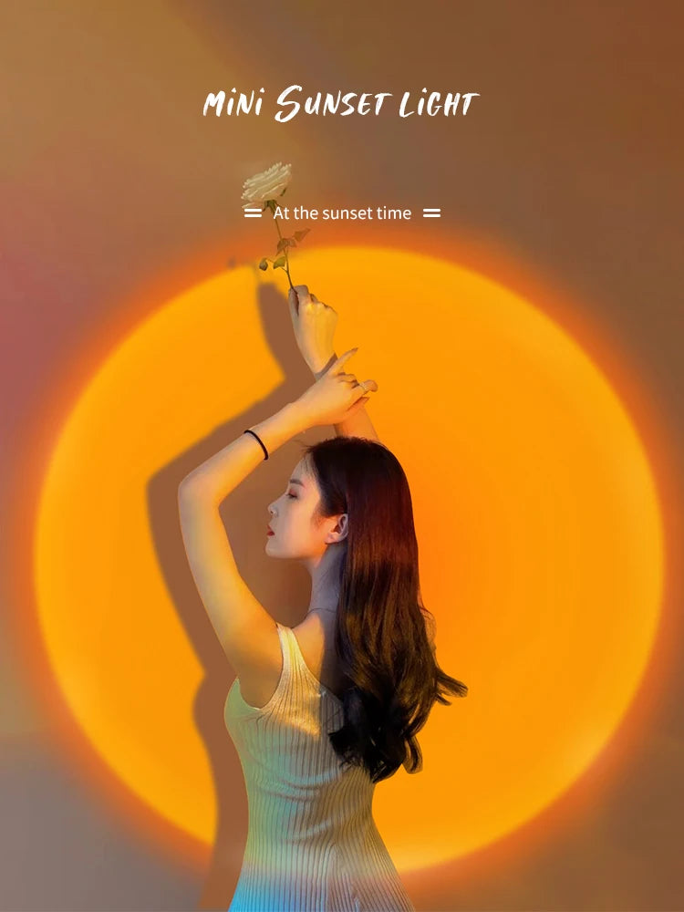 Mini sunset lamp casting a large, circular orange-yellow light glow on a wall for ambient room lighting.