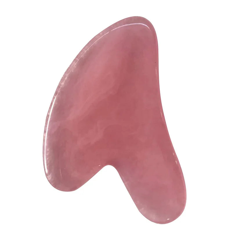 Rose quartz gua sha tool for facial massage with a curved, smooth-edged wing shape.