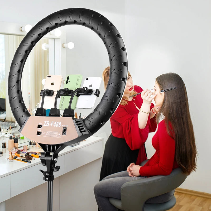 Large black circular LED ring light with three phone mounts, used for makeup application and video recording.