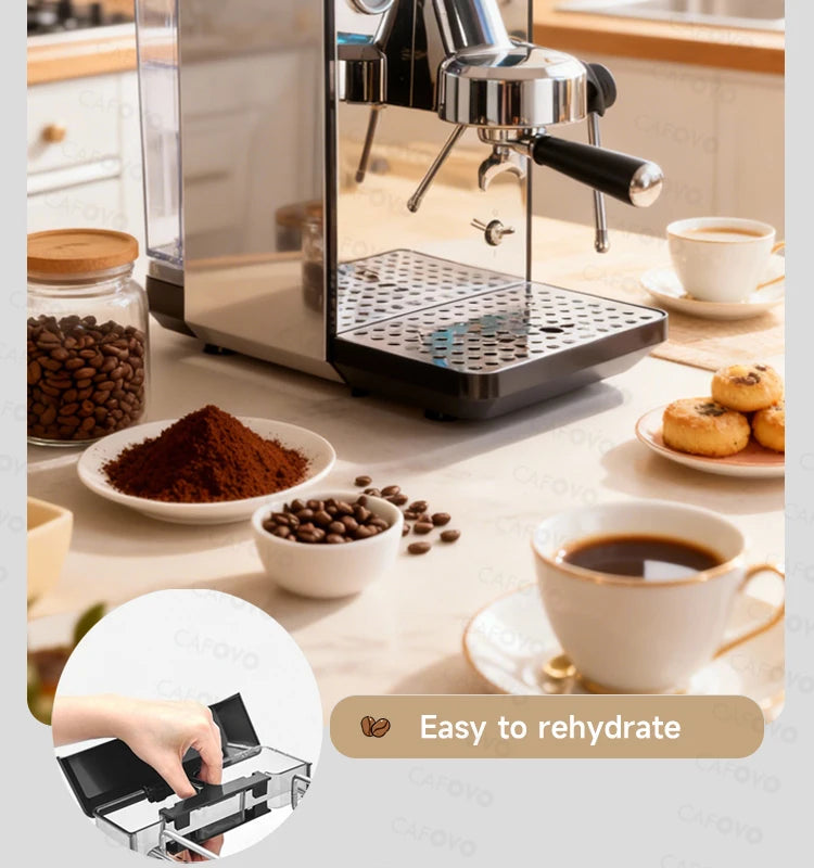Cafovo stainless steel espresso machine with portafilter and water reservoir on a kitchen counter with coffee beans.