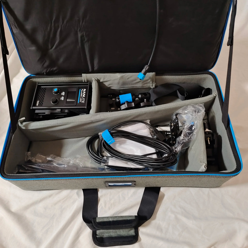 PavoSlim 120C LED panel, cables, and mounting hardware packed inside a grey and blue padded equipment carry case.