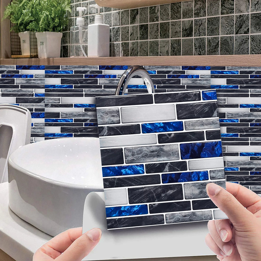 Hands applying self-adhesive 3D mosaic tile sticker sheet on a blue and gray brick wall.