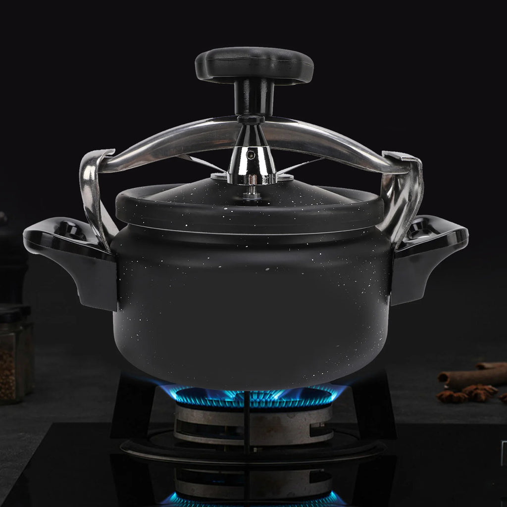 Black pressure cooker with domed lid, metal valve stem, and side grip handles