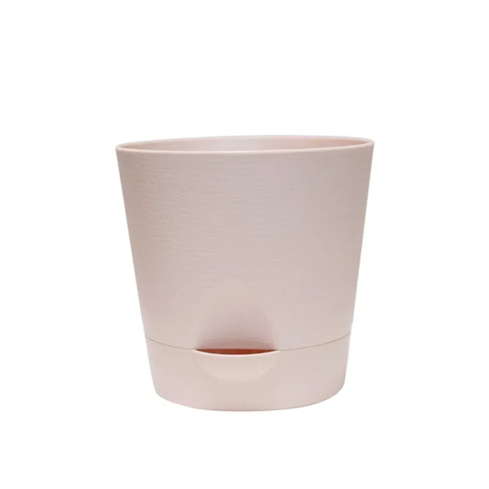 Light pink round plastic self-watering flower pot with removable bottom base