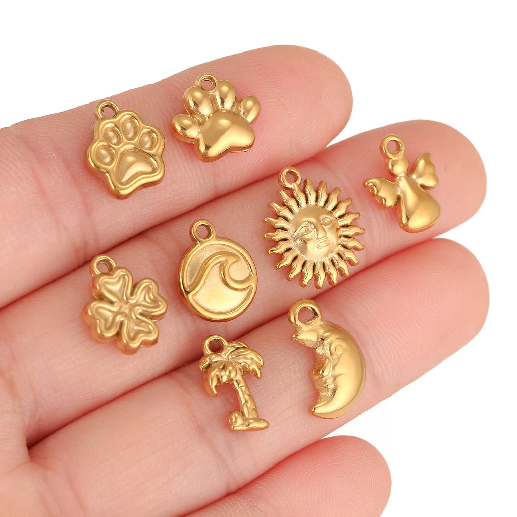 Gold stainless steel pet paw, sea wave, and sun charms for DIY jewelry making, necklaces, and custom pet bracelets.