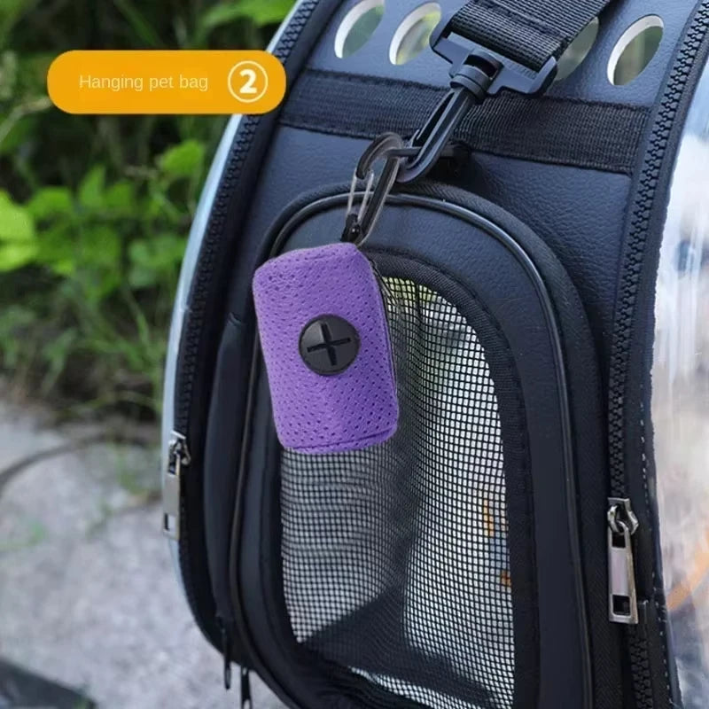 Purple portable dog poop bag dispenser with carabiner, easily clips to pet travel bags for convenient waste cleanup.