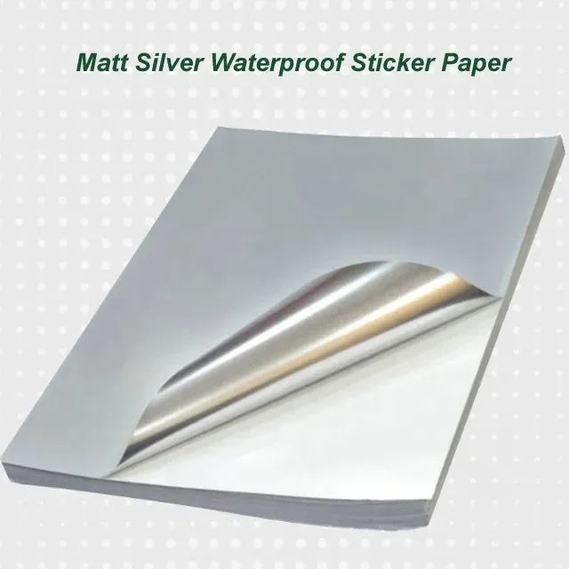 Matte silver waterproof sticker paper sheet with exposed silver liner and curl.