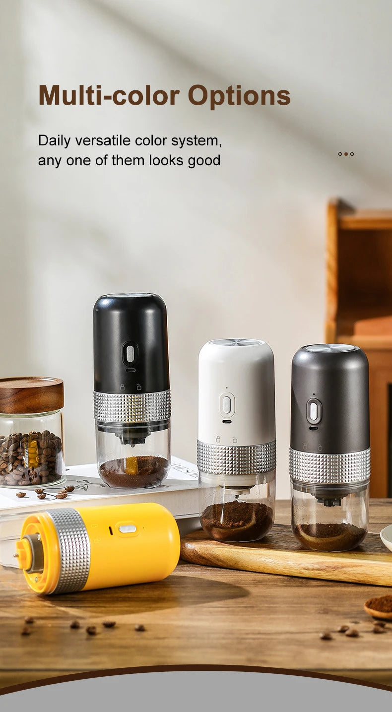 Portable electric coffee grinders in black, white, gray, and yellow with clear grounds containers on a wooden table.