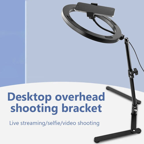 Black desktop ring light stand with an adjustable arm and phone holder for overhead filming, streaming, and video.