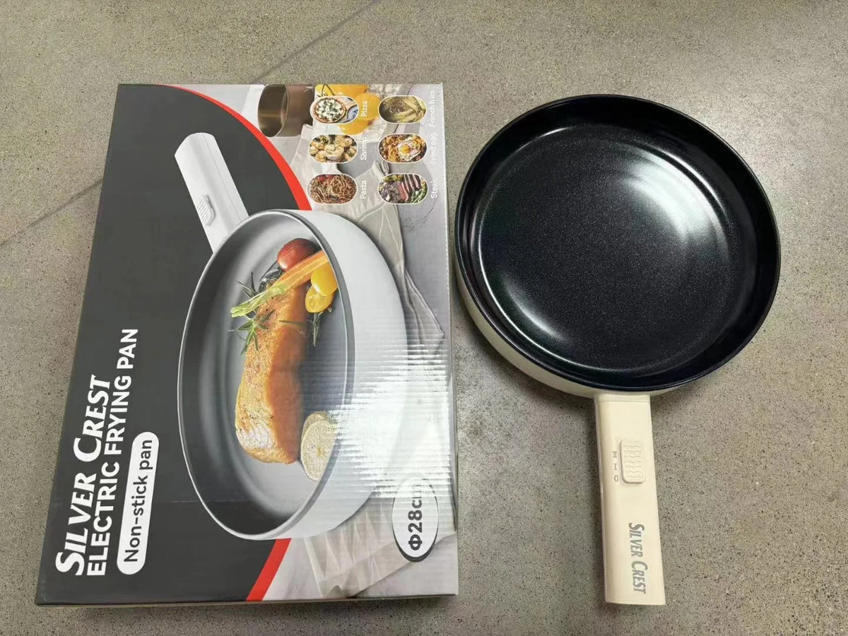 Electric frying pan kit with black pan and white handle, plus box and accessories