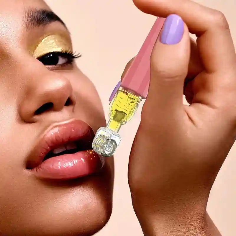 A hand holding a rose gold derma roller with a serum reservoir, being applied to a woman's glossy lips.