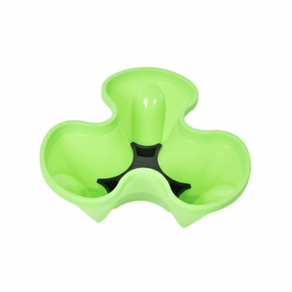 Green 4-petal plastic planter with central black drainage insert and four raised compartments