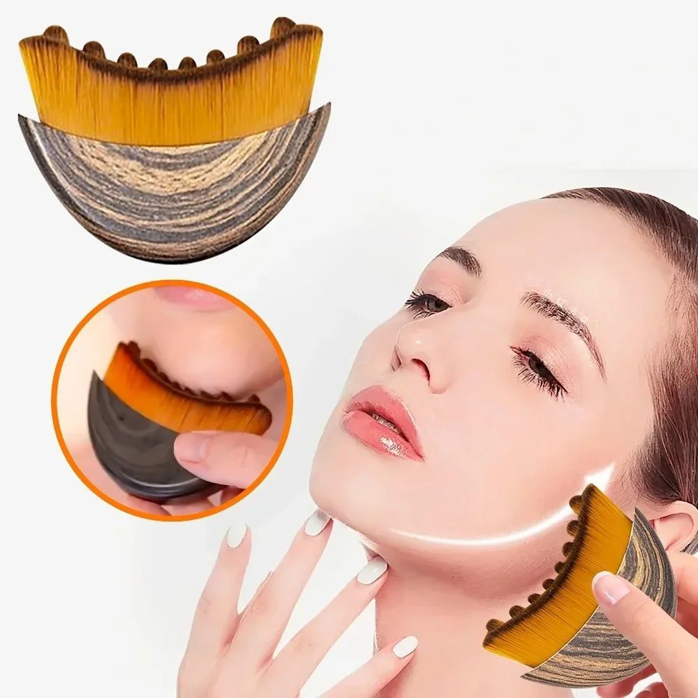 Curved lymphatic face brush with brown, wood-grain handle and soft yellow bristles, shown in use on a jawline.