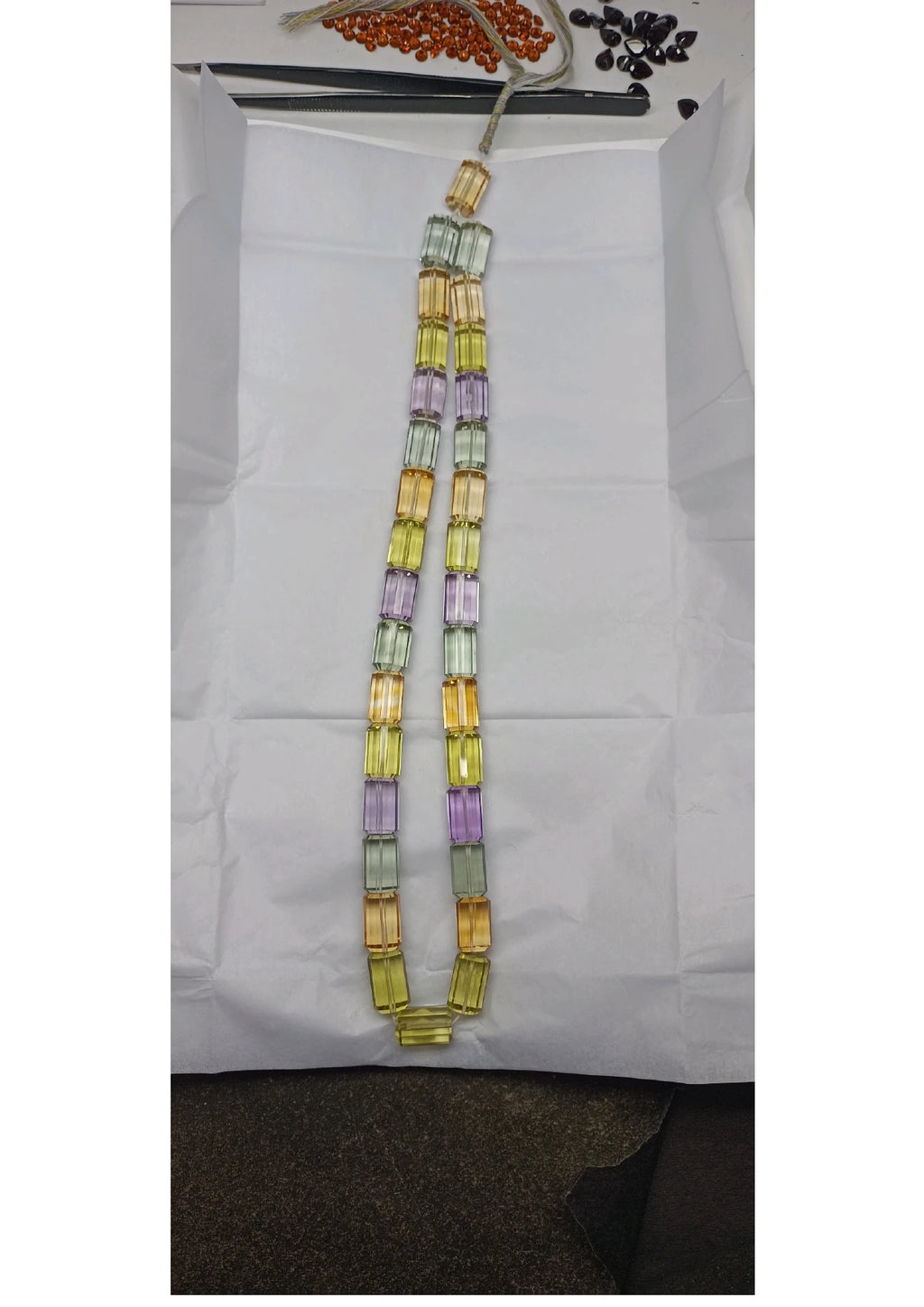 Faceted cylinder bead strand display: multicolor yellow, lavender, and mint beads