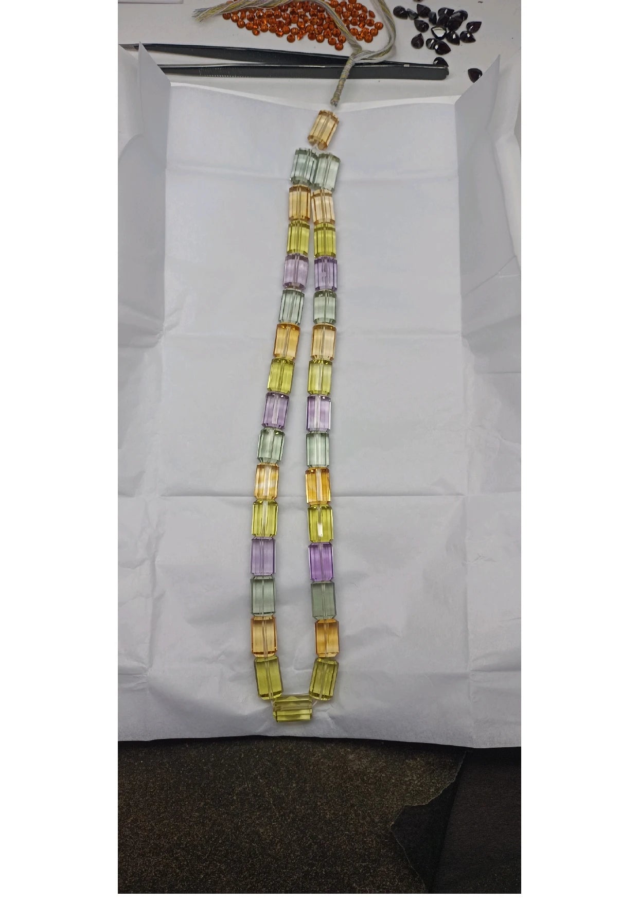 Faceted cylinder bead strand display: multicolor yellow, lavender, and mint beads