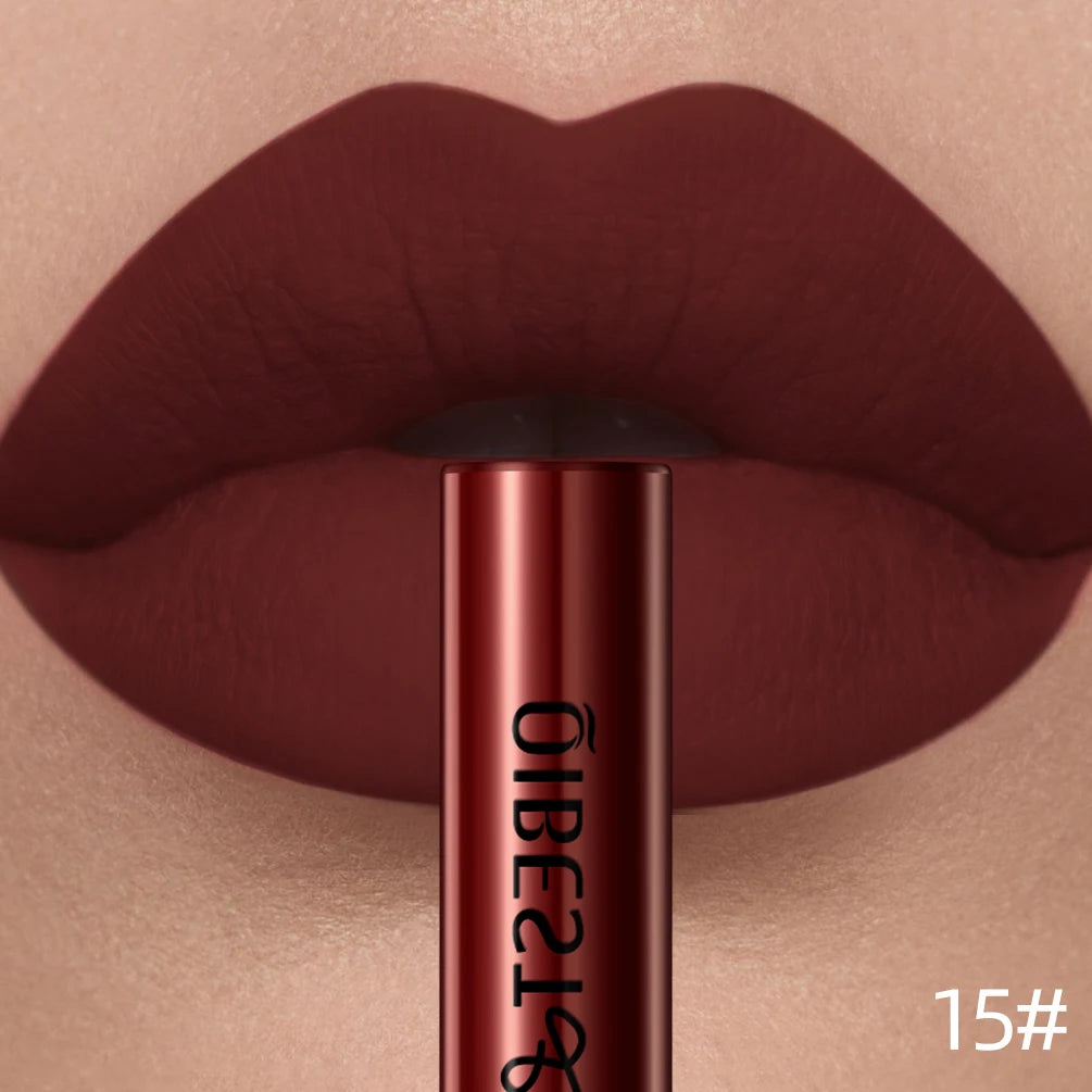 Deep red matte liquid lipstick on lips with a long-lasting, velvet, nonstick finish and matching applicator tube.