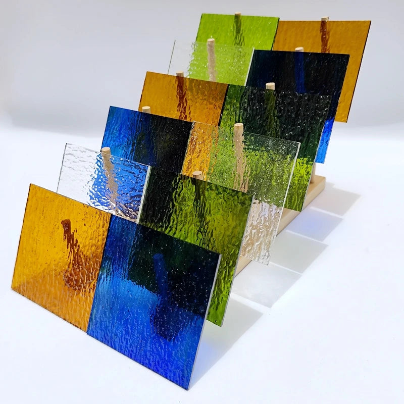 Assorted textured translucent stained glass square tiles, green, blue, yellow, black, white