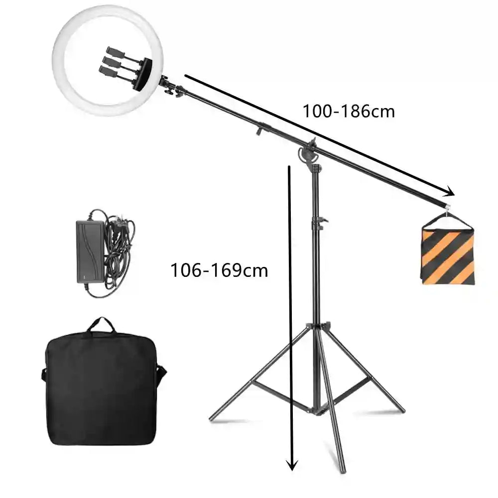 Black ring light on an adjustable boom arm stand with a tripod base, power supply, counterweight bag, and carry case.