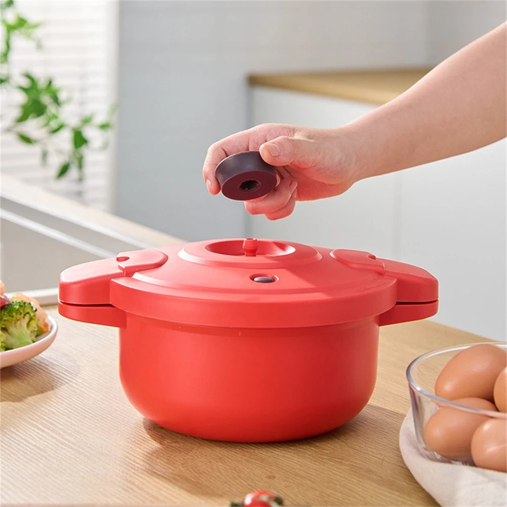 Red microwave pressure cooker with black lid knob, portable handles, and vent top