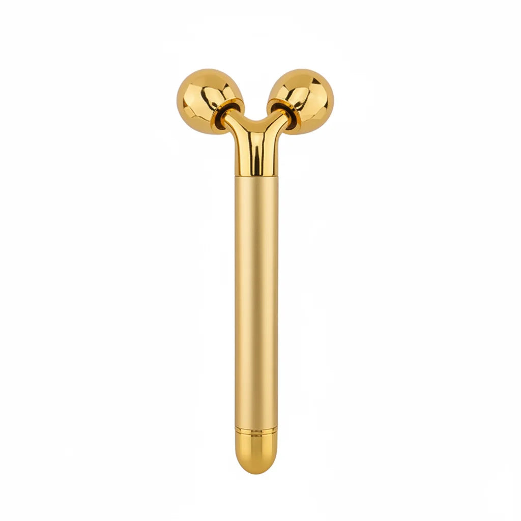 Gold Y-shaped facial massager with two smooth rotating balls on a slim, metallic handle against a white background.