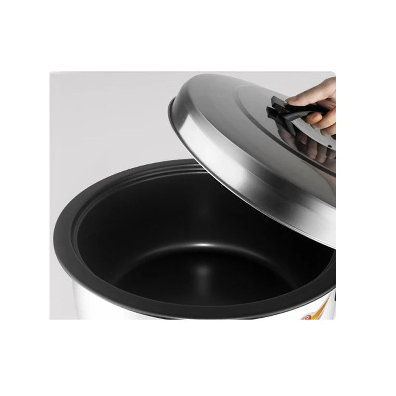 Commercial rice cooker cooking chamber with black inner pot and raised lid