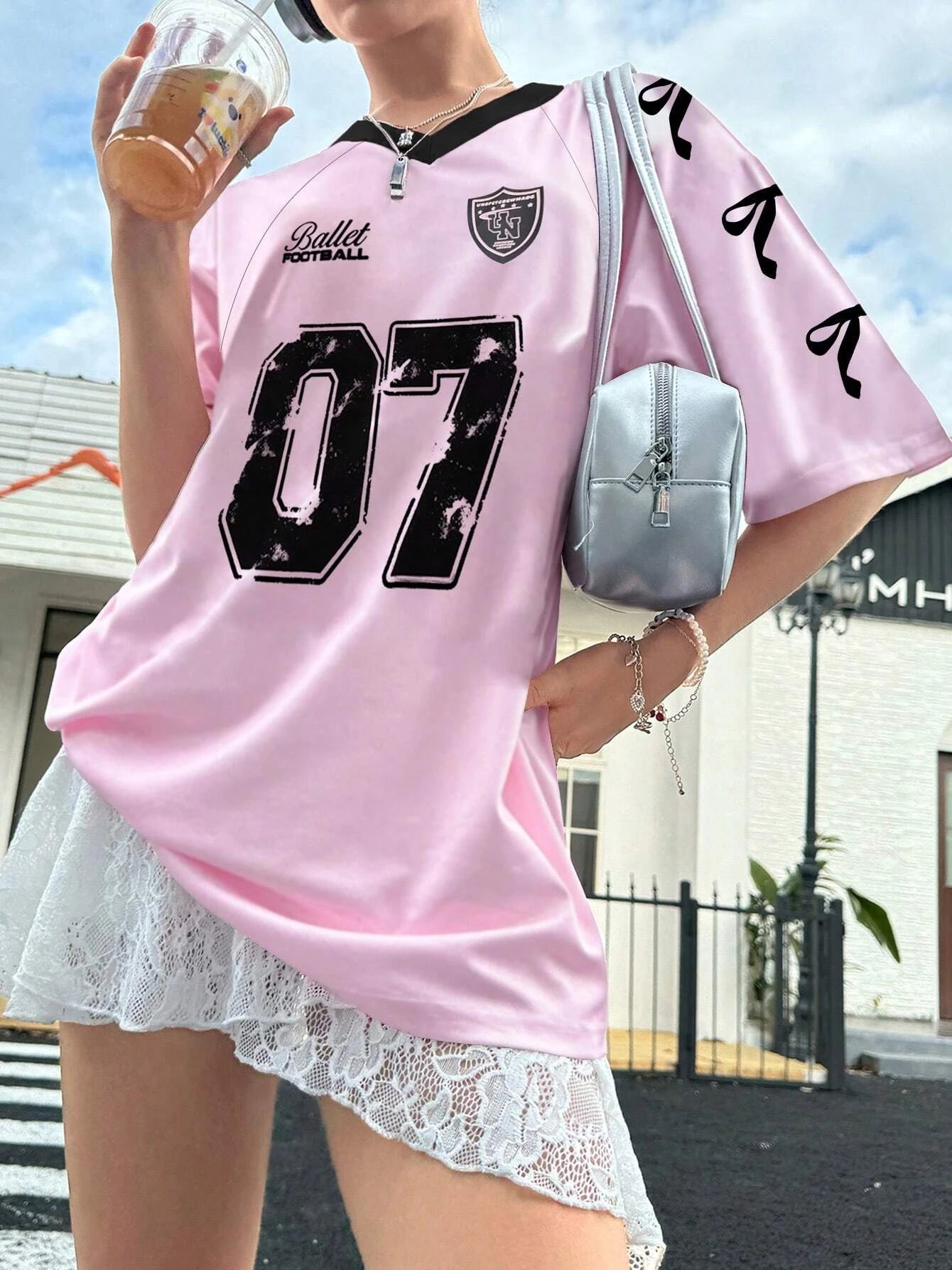 Tidesmit oversized light pink V-neck football jersey with black 07 print, short sleeves, and smooth athletic fabric.
