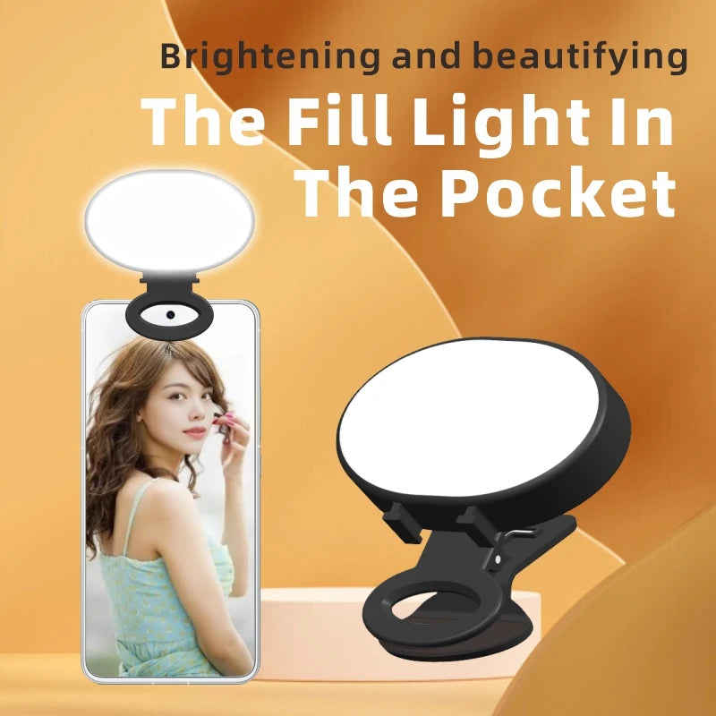 Black portable clip-on ring light for smartphones, used to provide illumination for selfies and videos.