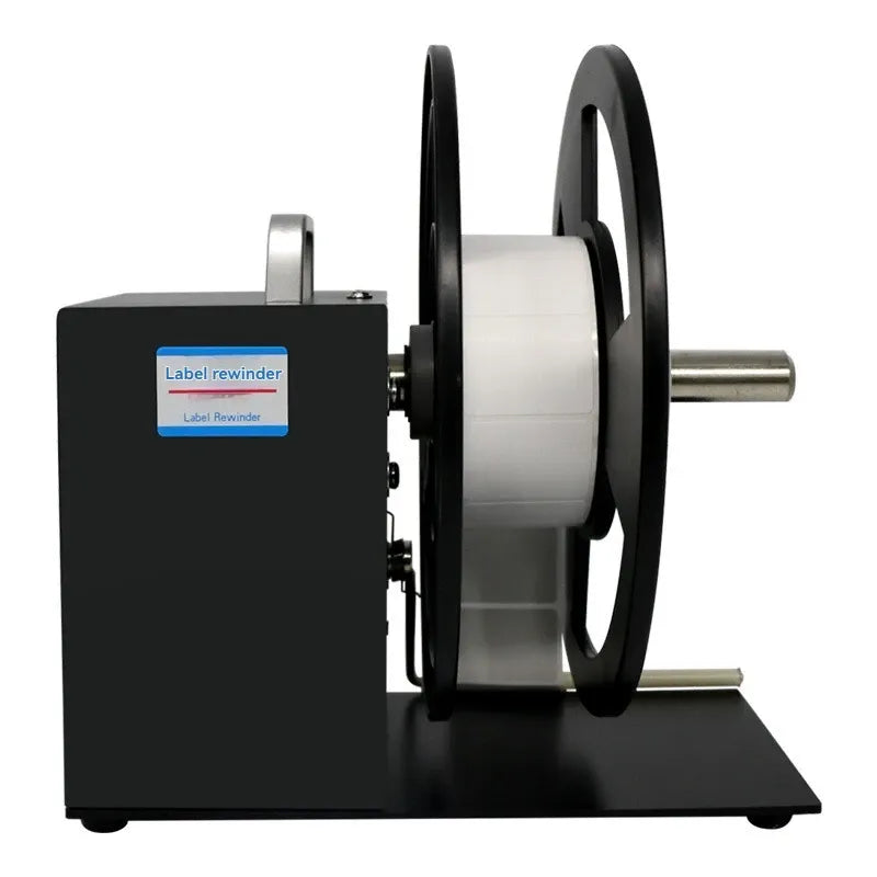 Label rewinder with front control box, spindle shaft, and mounted white label roll on reels